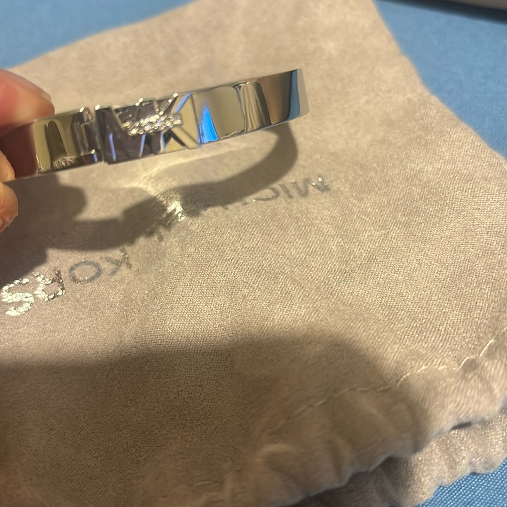 This is a silver tone, Michael Kors bracelet
